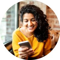 person smiling at a phone screen