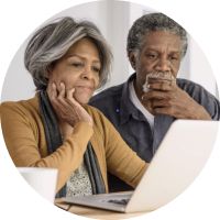 couple reading computer screen together