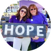 smiling people with a sign that reads Hope